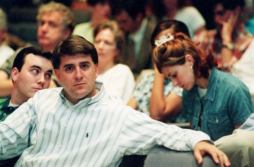 Columbia employees listen as Dr. Thomas Frist Jr. addresses a news conference