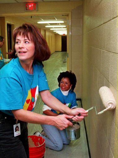 Columbia/HCA employees Nicci Cooper, of the accounting department, and Rebecca Gosey, of implementation services, help on Community Day in the Elam Center at Meharry Medical College on Nov. 14, 1997