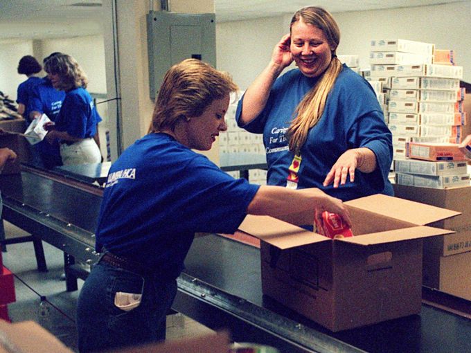 Karen Mason, left, and Janet Burgart load boxes of food at the Feed the Children warehouse at 615 Davidson St. on Sept. 18, 1998