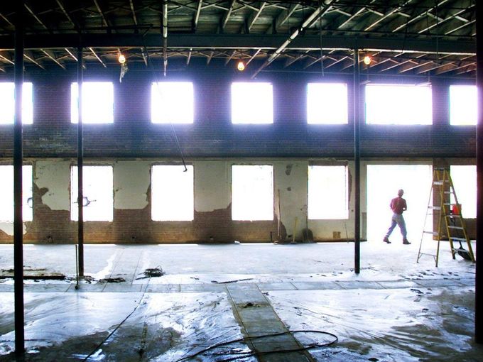 worker passes by an opening after windows were taken out of the old Nashville Kats facility on Charlotte Avenue June 3, 2002