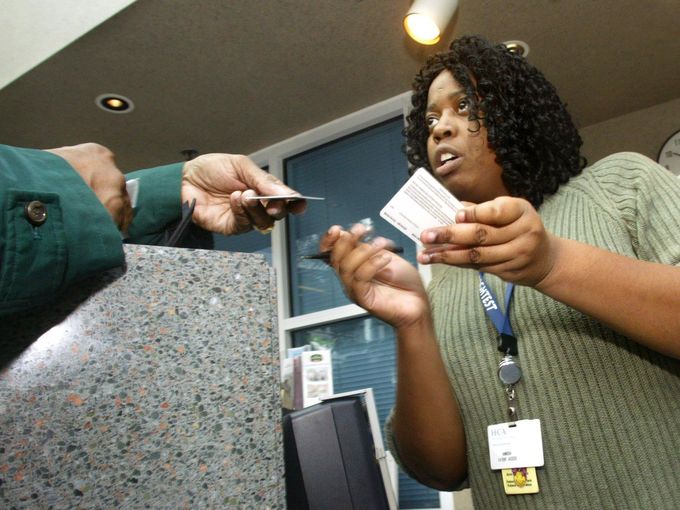 Annissa Moore takes patient information at the Centennial Medical Center patient registration desk Jan. 17, 2005