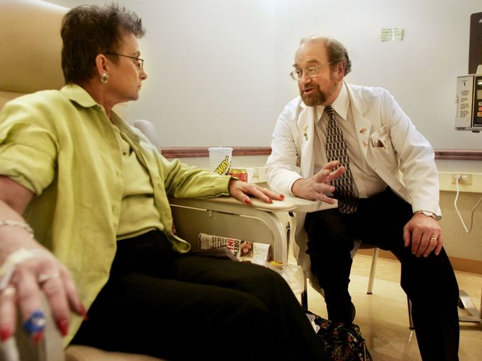 Anthony Greco, right, medical director at the Sarah Cannon Cancer Center, talks with patient Judy Yanko during her chemotherapy treatment April 21, 2005