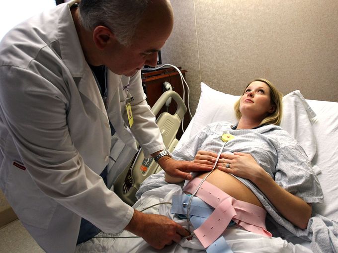 Kelly Cochrane gets her belly measured by Dr. John Wilters during a checkup at Centennial Women's Hospital on Dec. 21, 2009