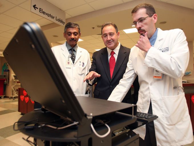 Jonathan Perlin, center, president of clinical services and chief medical officer with HCA, talks with Dr. Jayesh Patal, left, and Dr. Justin Collier about HCA's electronic health records technology at Skyline Medical Center on Aug. 27, 2010