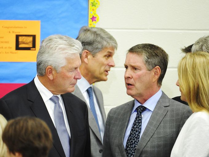 R. Milton Johnson, president and chief financial officer of HCA, left, talks with Sen. Bill Frist, right, before President Barack Obama arrives at Taylor Stratton Elementary School in Nashville on July 1, 2015